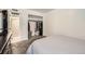 Carpeted bedroom with white walls, access to ensuite bathroom, closet, and dresser with TV at 3663 S Sheridan Blvd # 14, Denver, CO 80235