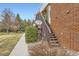Brick condo building with outdoor staircase leading to the units and satellite dishes on the building at 3663 S Sheridan Blvd # 14, Denver, CO 80235
