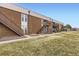 Two-story brick apartment complex with exterior stairways and well-maintained landscaping at 3663 S Sheridan Blvd # 14, Denver, CO 80235