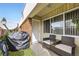 Inviting front patio with a seating area and green artificial turf, ideal for enjoying the outdoors at 3663 S Sheridan Blvd # 14, Denver, CO 80235