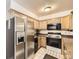 Galley kitchen featuring stainless steel appliances, ample cabinets and black microwave and oven at 3663 S Sheridan Blvd # 14, Denver, CO 80235