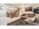 Inviting living room featuring an open floor plan, natural wood kitchen, and a comfortable reclining sofa at 3663 S Sheridan Blvd # 14, Denver, CO 80235