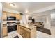 Open floor plan with eat in kitchen island flowing into the living room with a comfy couch at 3663 S Sheridan Blvd # 14, Denver, CO 80235