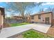 Backyard with concrete driveway, grassy area, and privacy fence at 2088 Kearney St, Denver, CO 80207
