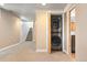 Finished basement with a modern stacked washer and dryer at 2088 Kearney St, Denver, CO 80207