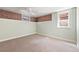 Light-filled basement room with fresh paint, exposed brick, and a ceiling fan at 2088 Kearney St, Denver, CO 80207