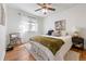 Cozy bedroom with hardwood floors, ceiling fan and white curtains at 2088 Kearney St, Denver, CO 80207