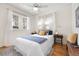 Bright bedroom with hardwood floors, ceiling fan and white bedding at 2088 Kearney St, Denver, CO 80207