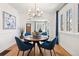 Elegant dining room with hardwood floors, modern chandelier, and ample natural light, perfect for Gathering meals at 2088 Kearney St, Denver, CO 80207
