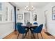 Cozy dining room featuring hardwood floors, a modern light fixture, and adjacent kitchen view at 2088 Kearney St, Denver, CO 80207