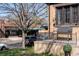 Charming front porch of a brick home with an elegant bench and manicured landscaping at 2088 Kearney St, Denver, CO 80207