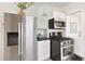 Updated kitchen features stainless steel appliances, white cabinets and dark countertops at 2088 Kearney St, Denver, CO 80207