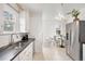 Updated kitchen features stainless steel appliances, white cabinets and access to a breakfast nook at 2088 Kearney St, Denver, CO 80207
