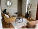 Cozy living room with stylish decor, including a glass coffee table, accent chairs, and hardwood flooring at 2088 Kearney St, Denver, CO 80207