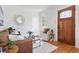 Bright living room featuring hardwood floors, decorative mirror, and a comfortable seating arrangement by the front door at 2088 Kearney St, Denver, CO 80207