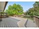 Large wooden deck with railings, offering a serene outdoor space surrounded by lush greenery at 19398 E Eastman Pl, Aurora, CO 80013