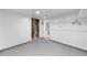 Basement storage area with painted floors, mechanical equipment, and access to the main living spaces at 19398 E Eastman Pl, Aurora, CO 80013