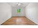 This bedroom features wood floors and a window that lets in natural light at 19398 E Eastman Pl, Aurora, CO 80013