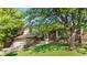 Charming two-story brick home with lush lawn, mature trees, and a welcoming front entrance at 19398 E Eastman Pl, Aurora, CO 80013