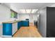 Well-lit kitchen featuring blue cabinets, butcher block countertops, and modern stainless steel appliances at 19398 E Eastman Pl, Aurora, CO 80013