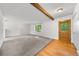 Spacious living area with neutral carpet, decorative beam, and inviting front door, perfect for relaxation at 19398 E Eastman Pl, Aurora, CO 80013