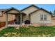 Back exterior view with covered patio, seating, grill, and well maintained lawn in a desirable neighborhood at 3469 Amber Sun Cir, Castle Rock, CO 80108