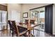 Open dining area with dark wood floors, a large table, and sliding glass doors to the backyard at 3469 Amber Sun Cir, Castle Rock, CO 80108
