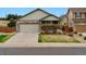 Charming single Gathering home featuring a stone and siding exterior, a two-car garage, and landscaped front yard at 3469 Amber Sun Cir, Castle Rock, CO 80108