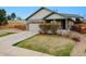 Charming home featuring a stone facade, attached garage, and well-maintained lawn at 3469 Amber Sun Cir, Castle Rock, CO 80108