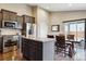 Modern kitchen boasts stainless steel appliances, a granite island, and an adjacent dining area with natural light at 3469 Amber Sun Cir, Castle Rock, CO 80108