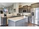 Updated kitchen with granite countertops, stainless steel appliances, and dark gray cabinets at 3469 Amber Sun Cir, Castle Rock, CO 80108