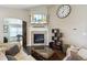 Inviting living room featuring a fireplace, hardwood floors, and comfortable sectional seating at 3469 Amber Sun Cir, Castle Rock, CO 80108