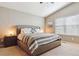 Bright main bedroom with vaulted ceiling, a large bed, and a window providing natural light at 3469 Amber Sun Cir, Castle Rock, CO 80108