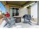 Cozy covered patio with comfortable seating, a fire pit, and a grill, ideal for outdoor entertaining at 3469 Amber Sun Cir, Castle Rock, CO 80108