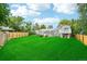 A spacious backyard featuring a well-maintained lawn and an elevated deck at 3932 S Pagosa St, Aurora, CO 80013