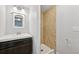 Compact bathroom with a vanity sink and a tiled shower stall at 3932 S Pagosa St, Aurora, CO 80013