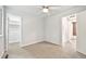 Bright bedroom featuring neutral paint, a ceiling fan, and doorway leading to an adjacent bathroom at 3932 S Pagosa St, Aurora, CO 80013