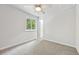 Sunlit bedroom featuring a ceiling fan and a bright window view at 3932 S Pagosa St, Aurora, CO 80013