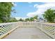 Outdoor deck with white lattice railing offers a pleasant view of surrounding trees and neighborhood at 3932 S Pagosa St, Aurora, CO 80013