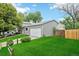 Side view of home featuring a well-manicured lawn, attached garage, and complemented by mature trees at 3932 S Pagosa St, Aurora, CO 80013