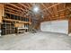 An unfinished two-car garage showing exposed framing and concrete floor at 3932 S Pagosa St, Aurora, CO 80013
