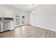 Open kitchen boasts stainless appliances, white cabinets, and backyard access at 3932 S Pagosa St, Aurora, CO 80013
