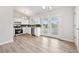 Modern kitchen features stainless appliances, white cabinets, and access to the backyard at 3932 S Pagosa St, Aurora, CO 80013
