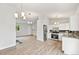 Bright, open living space with stairs, modern kitchen, and luxury vinyl flooring at 3932 S Pagosa St, Aurora, CO 80013