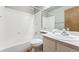 Bathroom with a tub and shower combination, vanity with sink, and a mirrored medicine cabinet at 5372 E 108Th Pl, Thornton, CO 80233