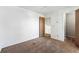 Bedroom featuring neutral carpet, white walls, and access to a stairway at 5372 E 108Th Pl, Thornton, CO 80233