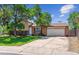 Traditional two-story brick home with mature trees, attached two-car garage, and well-manicured lawn at 5372 E 108Th Pl, Thornton, CO 80233