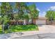 Charming two-story home with a brick facade, attached garage, and mature trees in a sunny, landscaped front yard at 5372 E 108Th Pl, Thornton, CO 80233