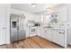 Light and bright kitchen featuring stainless steel refrigerator and white appliances and cabinets with views to the yard at 5372 E 108Th Pl, Thornton, CO 80233