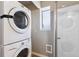 Laundry room featuring stackable washer and dryer at 5372 E 108Th Pl, Thornton, CO 80233